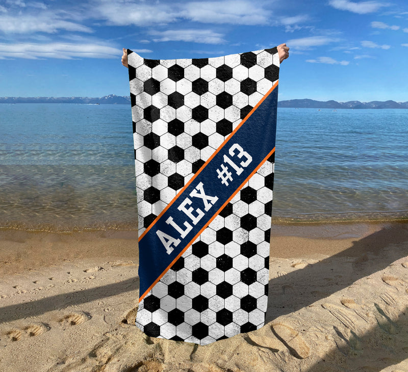a towel with a name on it on a beach