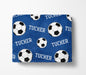 a blue blanket with a repeating pattern of soccer balls and the name "Tucker" printed on it.
