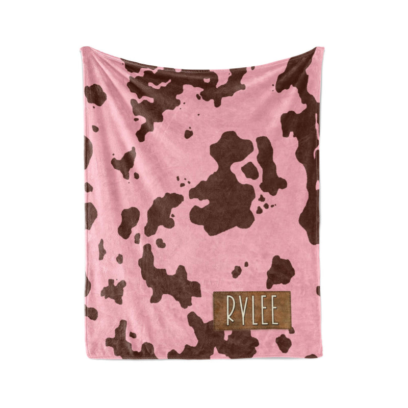 a pink blanket with a cow print pattern.