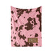 a pink blanket with a cow print pattern.