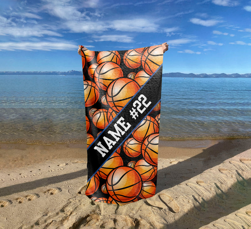 a surfboard with basketballs on it on the beach