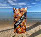 a surfboard with basketballs on it on the beach