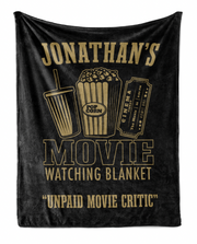 The image is a black banner with gold text and illustrations related to a movie watching experience.