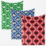 three fabric items with a repeating pattern of the letters 'XC' in different colors: green, blue, and red.