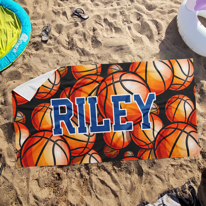 a towel with the word riley on it laying in the sand