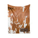 a blanket with a cowhide pattern and the name "OAKLEY" printed on it.