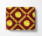 a red blanket with a repeating pattern of yellow softball images and the name "Emory" written in white.