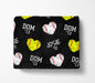 a black blanket with a repeating pattern of baseballs and hearts in yellow and white colors.
