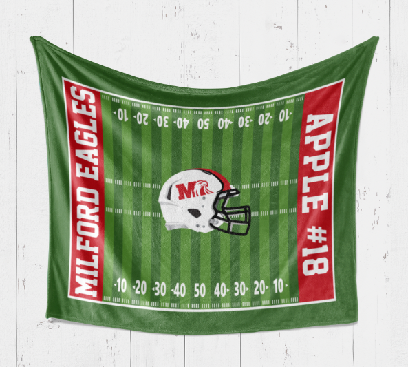 A green towel with red and white text and an image of a football helmet on it.