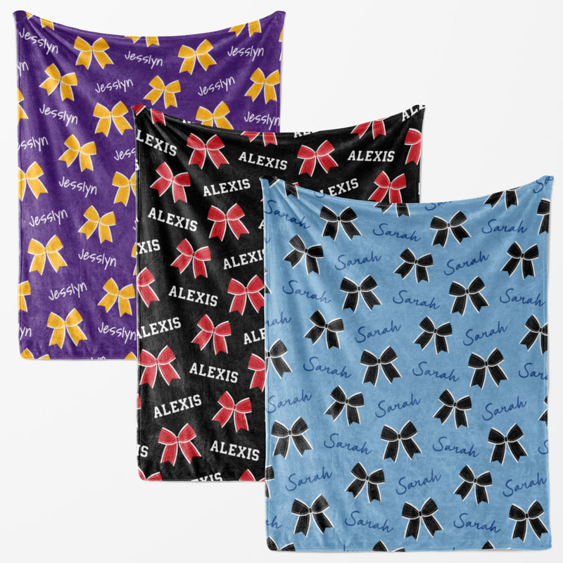 three different blankets with the same pattern of bows and the name "Alexis" printed on them.