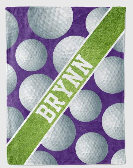A personalized golf ball blanket with the name "BRYNN" printed on it, featuring a pattern of white golf balls against a purple background.
