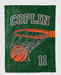 A green blanket with a basketball net and a basketball printed on it.