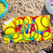 a beach towel with softballs and the word ava on it