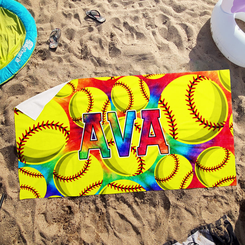 a beach towel with softballs and the word ava on it