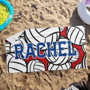 a towel with the word rachel on it laying in the sand