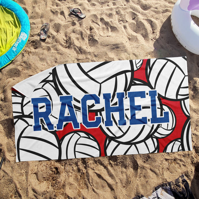 a towel with the word rachel on it laying in the sand