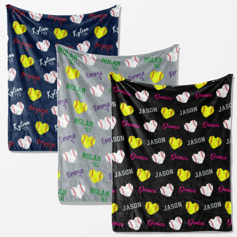 three different blankets with a pattern of baseballs and hearts, each with the name of a person printed on it.