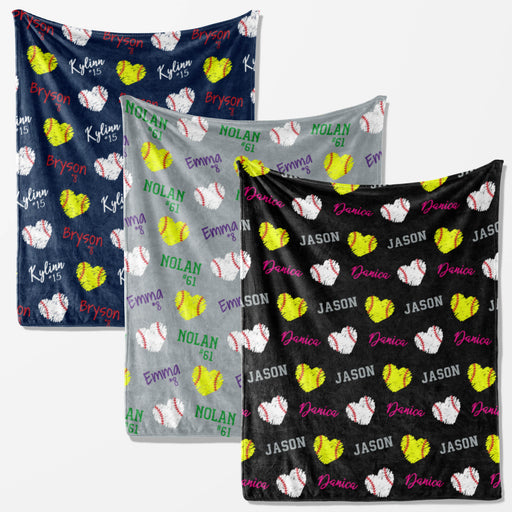 three different blankets with a pattern of baseballs and hearts, each with the name of a person printed on it.