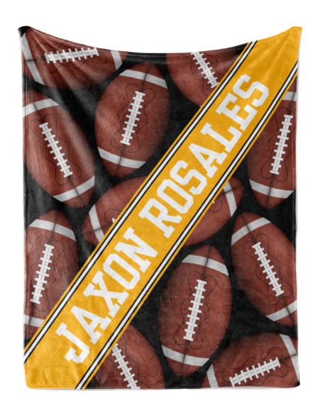 A blanket with a repeating pattern of footballs in various shades of brown and white, with the name "JAXON ROSALES" printed in bold yellow letters diagonally across the blanket.