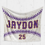 A white banner with purple text and a baseball design, hanging on a white wooden wall.