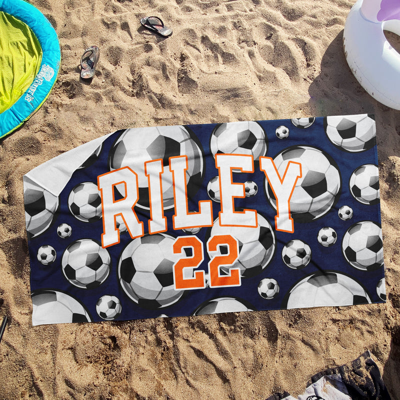 a beach towel with soccer balls on it