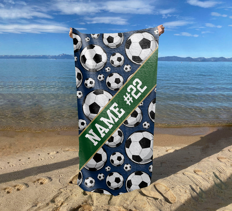 a beach towel with soccer balls on it