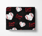a black blanket with a repeating pattern of white baseball hearts and the name "Liam" written in red cursive.