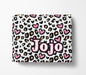 A white blanket with a leopard print pattern and pink hearts. The word "Jojo" is written in pink letters on the blanket.