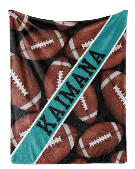 A black and teal blanket with a repeating pattern of footballs and the name "KAIMANA" printed on it.