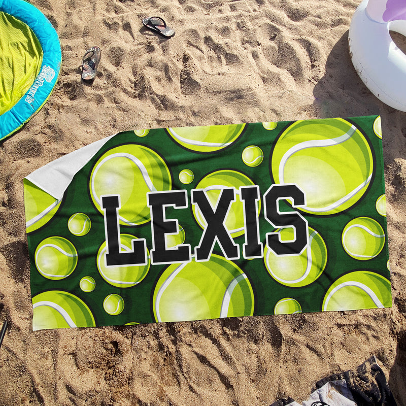 a towel with a name on it laying in the sand
