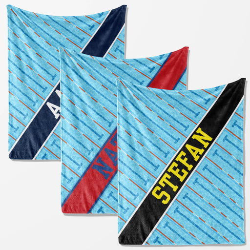 three different blankets with a striped pattern. The first blanket has a blue and white striped pattern, the second blanket has a red and white striped pattern, and the third blanket has a black and white striped pattern.