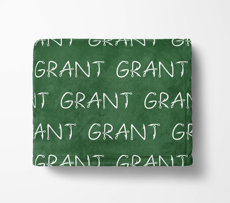 The image is a green blanket with the word "GRANT" repeated multiple times in white text.