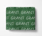 The image is a green blanket with the word "GRANT" repeated multiple times in white text.