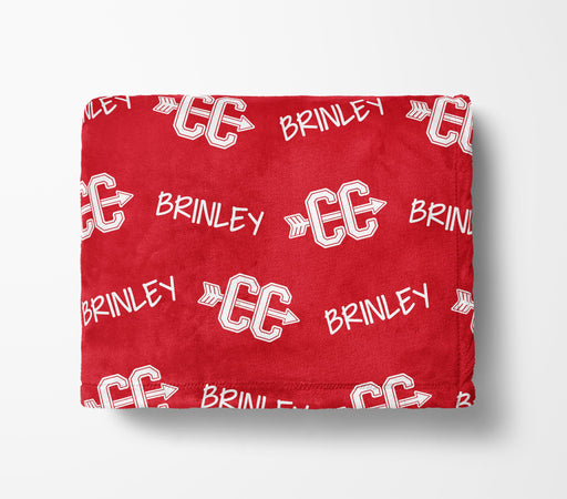 The image is a red blanket with white text and logos printed on it.